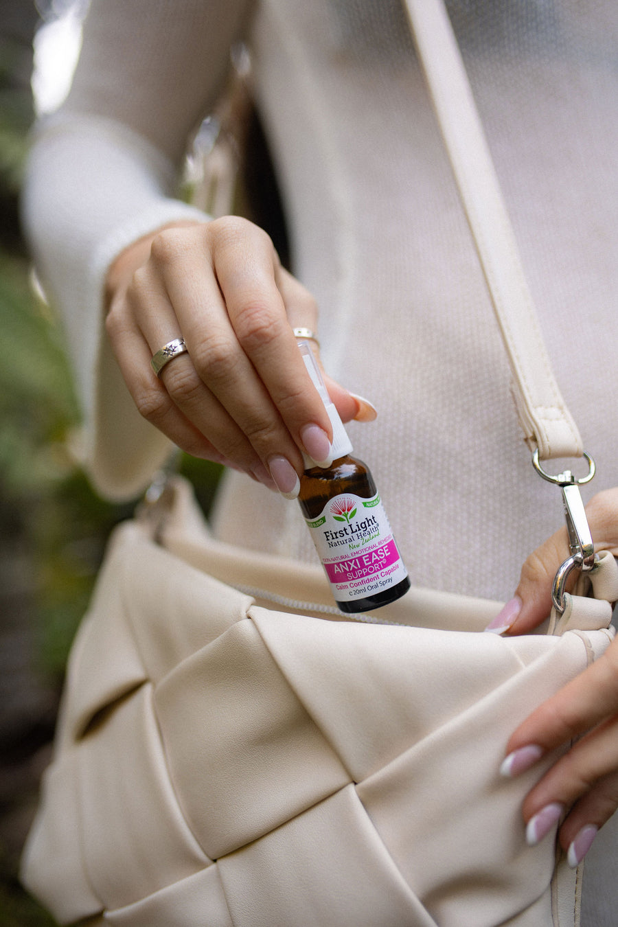 Anxi Ease Support oral spray being taken from a cream handbag