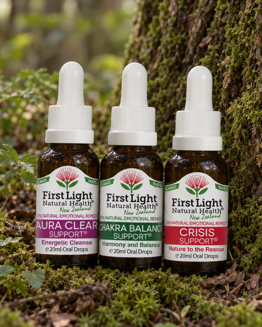 Aura Clear Support, Chakra Balance Support and Crisis Support oral drops at the base of a tree in native New Zealand forest