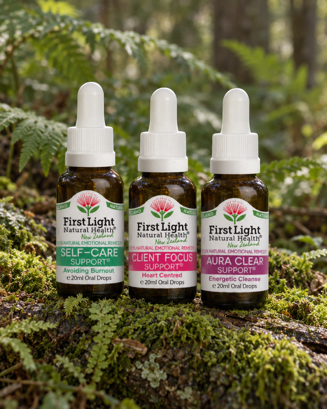 Self-Care Support, Client Focus Support and Aura Clear Support oral drops on a mossy log in native New Zealand forest