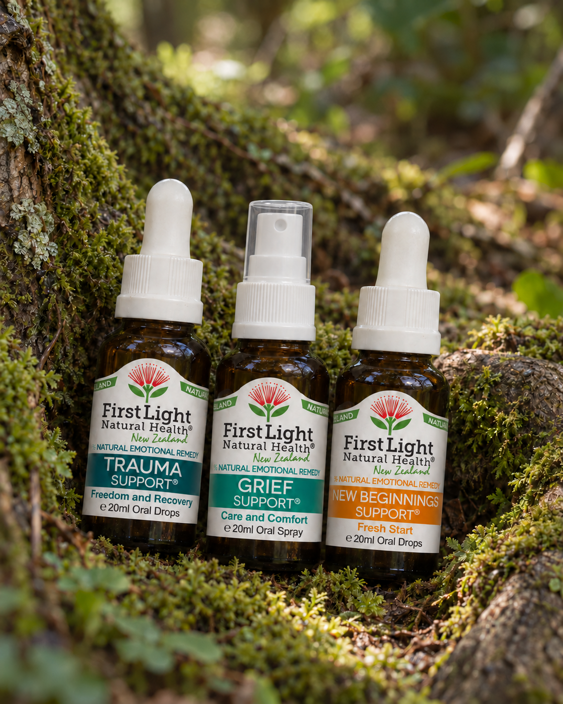 Trauma Support oral drops, Grief Support oral spray and New Beginnings Support oral drops nestled in moss in native New Zealand forest