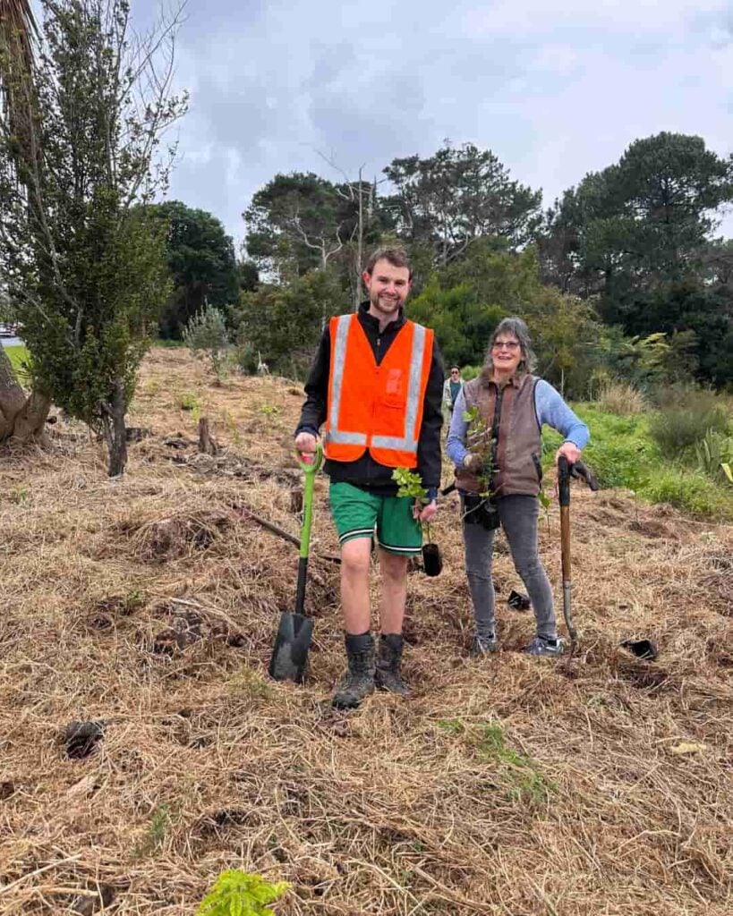 Cameron and Jeanette from First Light Flower Essences of New Zealand planting native trees as part of the Growing Good initiative with Trees That Count.